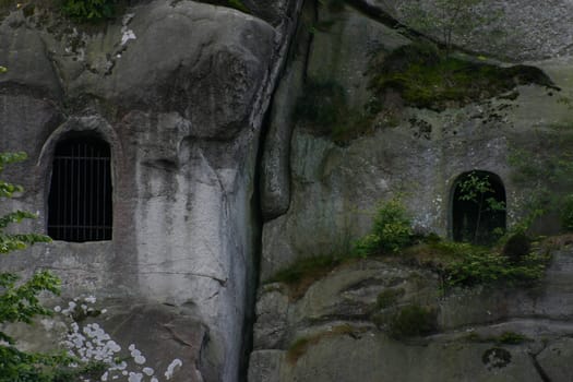 Barred window openings in the external stones. Behind it are two rock grotes,which unfortunately are no longer open to the public