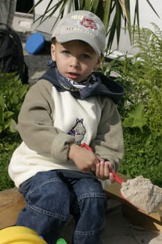 Boy playing in sandbox