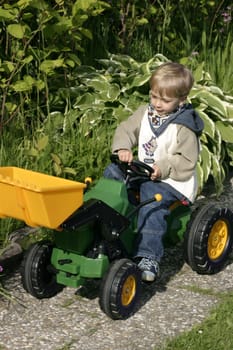 Boy playing with the toy excavator