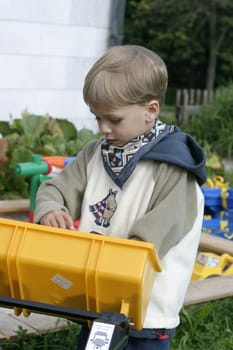 Boy honking his horn driving toy excavator