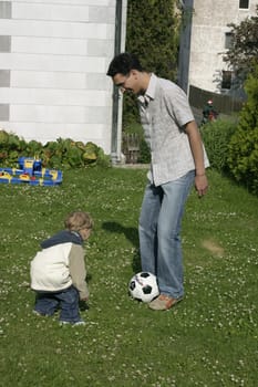 Father and son playing football