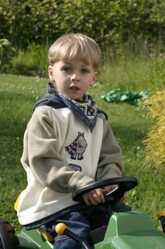 Boy honking his horn driving toy excavator