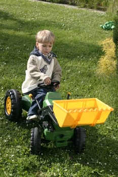 Boy playing with the toy excavator
