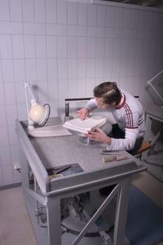 Vocational school students working on a plaster mold for the production of logo porcelain