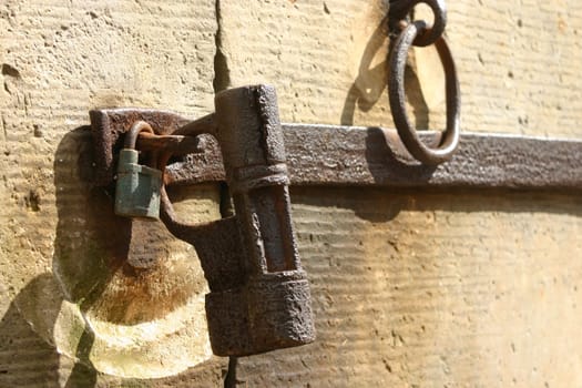 Ancient and newer padlock on the heavy stone door to the mausoleum of the Counts of Alverdiss (Alverdissen,town of Barntrup,district of Lippe)