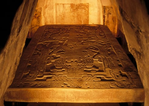 The burial chamber under the Temple of Inscriptions. Today you can only admire it behind a tarnished plexiglass pane,the plate with the dimensions 3.8m x 2.2m,a thickness of 25cm,and a weight of several tons.