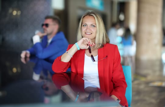 Portrait of businesswoman in red jacket at bar. Modern women's career building concept