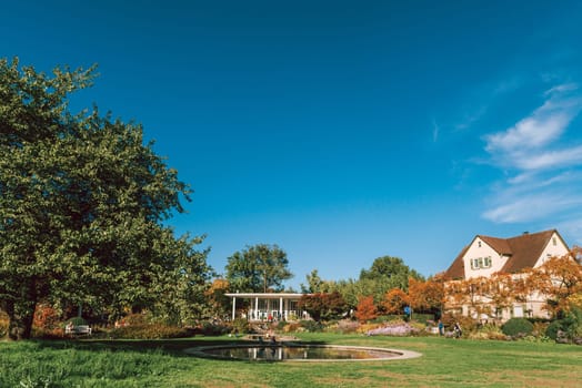 House with nice garden in fall. Flowers in the Park. Bietigheim-Bissingen. Germany, Europe. Autumn Park and house, nobody, bush and grenery