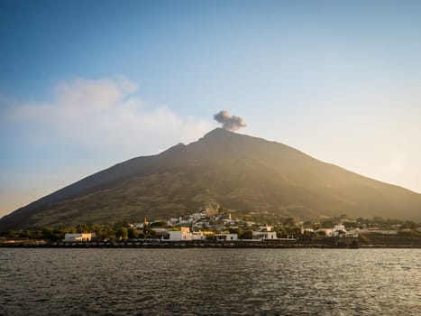 A large volcano spewing smoke into the sky. Photo of a powerful volcano erupting on an Italian island in Sicily