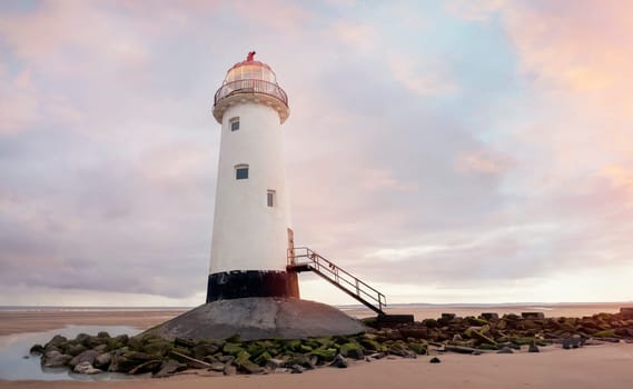 view of a lighthouse standing at the coast of Wales the North Sea at sinrise, United Kingdom
