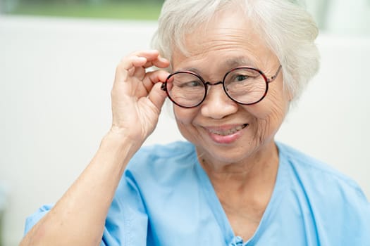 Asian senior woman wearing eyeglasses or vision glasses at home care service.