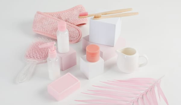 Skincare routine. Pink Women skincare products on white background. Soap, facial foam, cleansing, serum, cream lotion, toothbrush, lipstick. Beauty concept. Natural cosmetic pink flat lay top view.