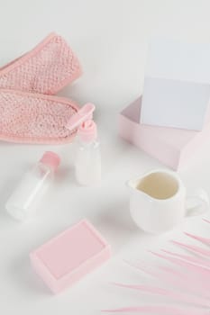 Skincare routine. Pink Women skincare products on white background. Soap, facial foam, cleansing, serum, cream lotion, toothbrush, lipstick. Beauty concept. Natural cosmetic pink flat lay top view.