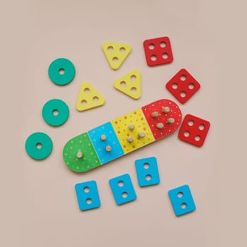 Sorter on neutral background. Multicolored logic sorter close up. Wooden educational logic toy for kid's. Montessori games for early child development.