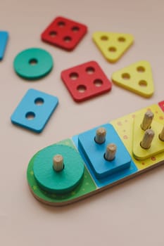 Sorter on neutral background. Multicolored logic sorter close up. Wooden educational logic toy for kid's. Montessori games for early child development.