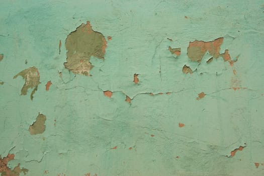 Old cracked green paint on the wall