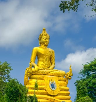 Golden Buddha statue next to famous statue of Big Buddha made of marble by day in Phuket, Thailand