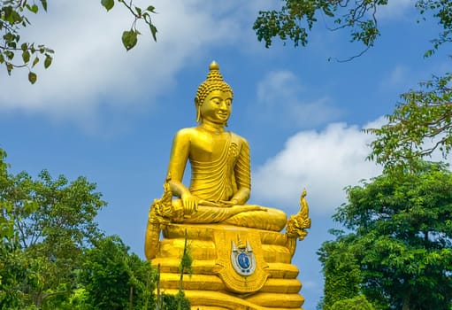 Golden Buddha statue next to famous statue of Big Buddha made of marble by day in Phuket, Thailand
