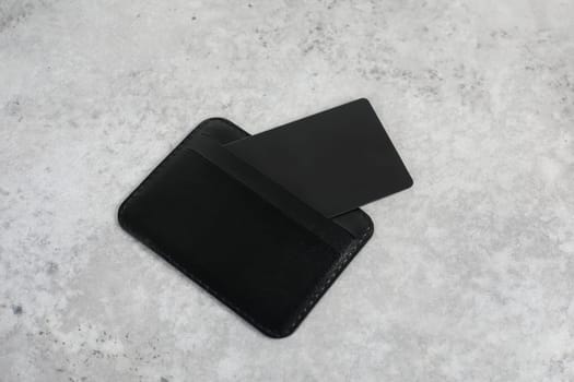 Black business leather card holder isolated on grey background. Logo design presentation.