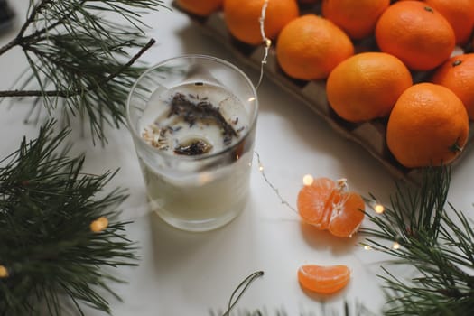 Candle, tangerines and pine. Christmas background with fir tree branches and tangerines merry christmas and happy new year. High quality photo