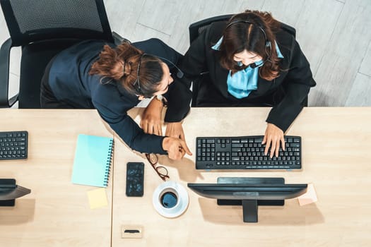 Business people wearing headset shot from top view in office working with computer. Jivy