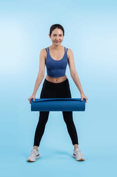 Young attractive asian woman portrait in sportswear with exercising mat. Healthy exercise and workout routine lifestyle concept. Studio shot isolated background. Vigorous