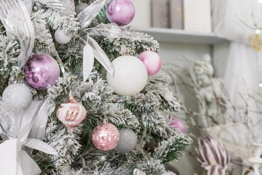 Beautiful decorated Christmas tree and pink boxes with gifts