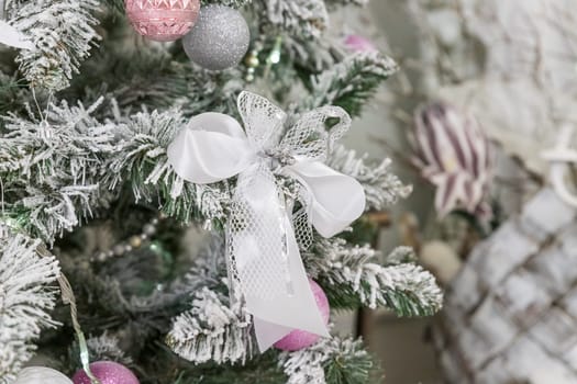 Beautiful decorated Christmas tree and pink boxes with gifts