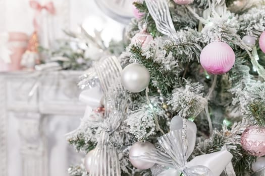 Beautiful decorated Christmas tree and pink boxes with gifts