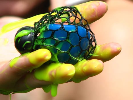 I can't say exactly what the toy is called. It is a kind of rubber ball filled with a somewhat viscous rubber mass (slimy). And usually throws yellow bubbles when you press it. In this case,the friend had pressed a little too hard,and was