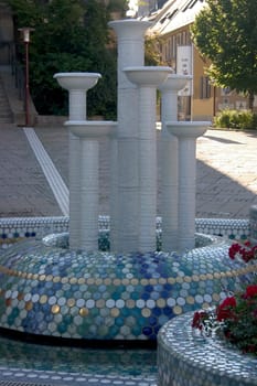 The porcelain fountain in the city of porcelain - Selb,Martin-Luther-Platz. The porcelain fountain,redesigned in 2003 by the porcelain manufactory Barbara Flügel,which sets a striking spotlight in fresh blue and turquoise tones and its ed
