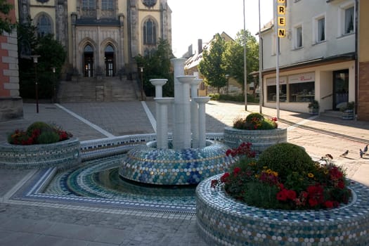 The porcelain fountain in the city of porcelain - Selb,Martin-Luther-Platz. The porcelain fountain,redesigned in 2003 by the porcelain manufactory Barbara Flügel,which sets a striking spotlight in fresh blue and turquoise tones and its ed