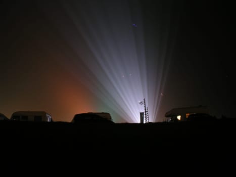 On the edge of the kite festival,rays of light between the campers on the dike.