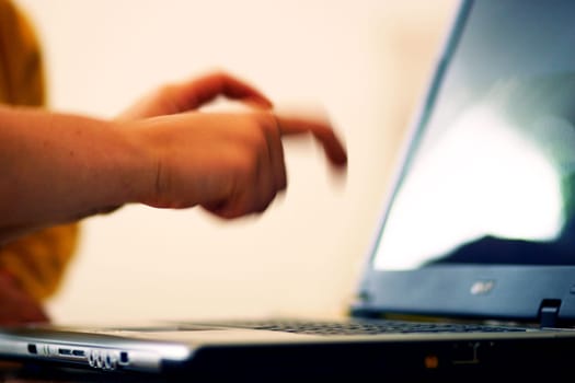 Typing on a laptop