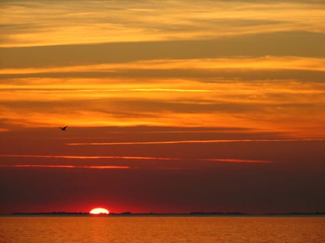 The sun sinks behind the island of Omo,photographed from the island of Vjerö.