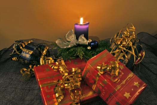 Christmas arrangement with candle and gifts