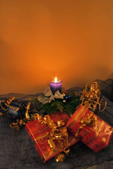 Christmas arrangement with candle and gifts