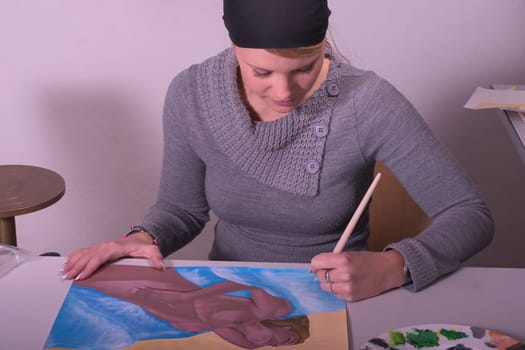 High school student painting a female nude