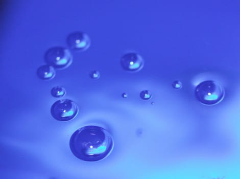 The water droplets sink into the water.