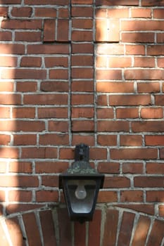 Lantern and brick cross above the entrance to the cemetery chapel in Hamelin