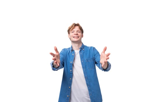 young friendly man with red hair in a blue shirt and white t-shirt.