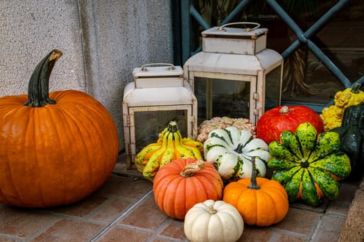 Series of colorful market pumpkins in front of the front door