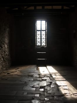 Empty stone room with window, creepy vibe, dungeon of loneliness for a prisoner. AI