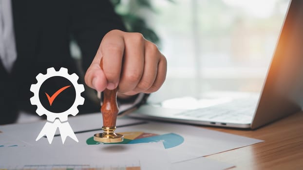 Businessman hand using wooden stamping to document approve and reject document or project, Signing a business contract approval of contract documents confirmation, approval stamp, copy space.