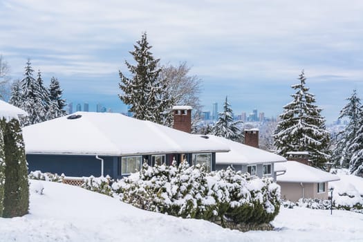 Street of residential houses in suburban of Vancouver. Family houses in snow on winter season