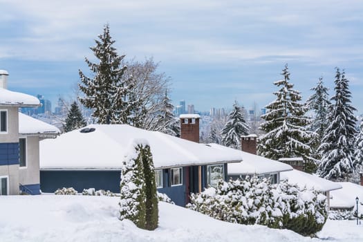 Street of residential houses in suburban of Vancouver. Family houses in snow on winter season