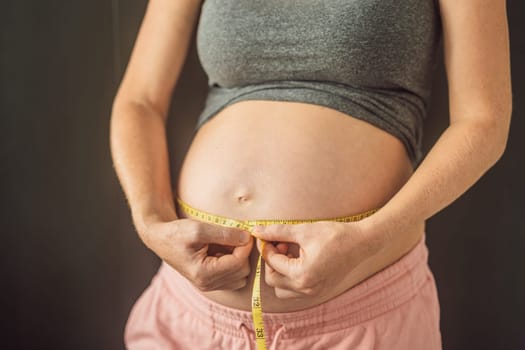 Young woman measuring her pregnant belly with centimeter tape. Centimeters European standard. Preparation for childbirth, Girl big belly advanced healthy pregnancy.