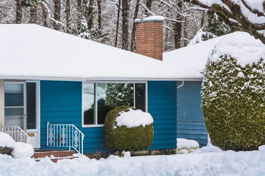 Entrance of residential house with front yard in snow. Family house on winter cloudy day