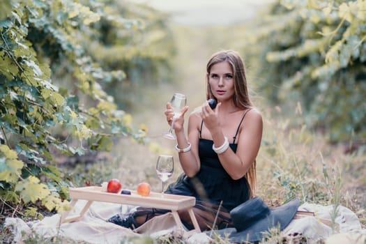 Picnic and wine tasting at sunset in the hills of Italy, Tuscany. Vineyards and open nature in the summer. Romantic dinner, fruit and wine.