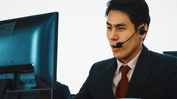 Business people wearing headset working in office to support remote customer or colleague. Call center, telemarketing, customer support agent provide service on telephone video conference call. Jivy